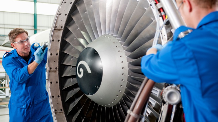 Aerospace engineers inspecting a jet engine