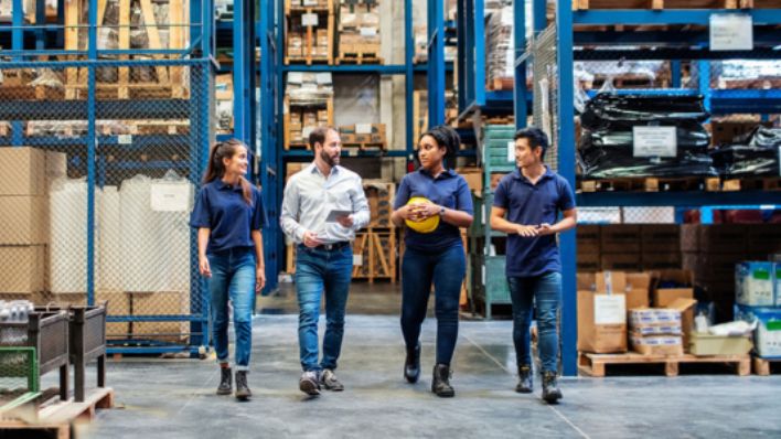 A group of warehouse workers talking.